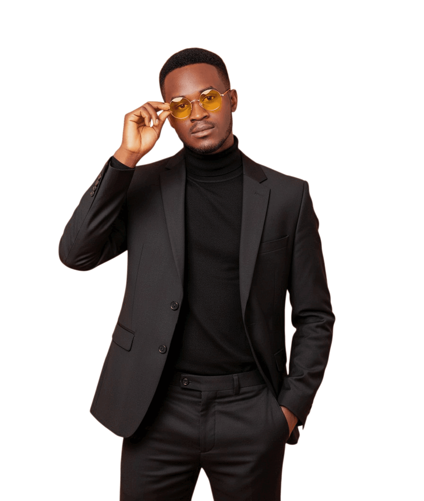 Bro. Nungu in a black suit and turtleneck, adjusting round yellow-tinted glasses.